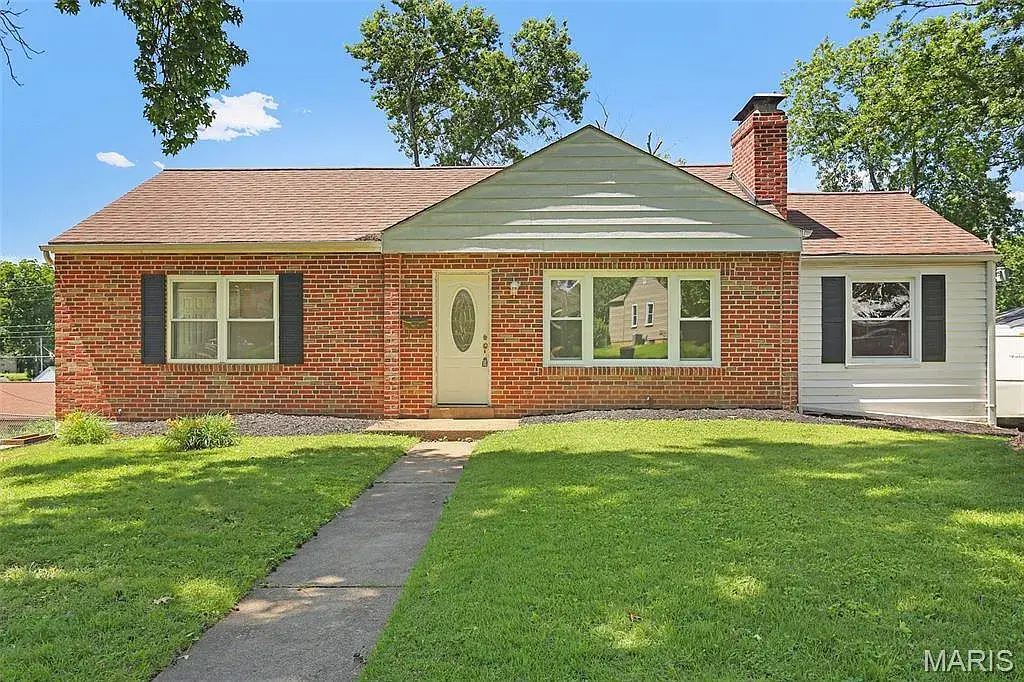 Brick house in Affton after Swift Home Buys bought it, with the yard and landscaping cleaned up