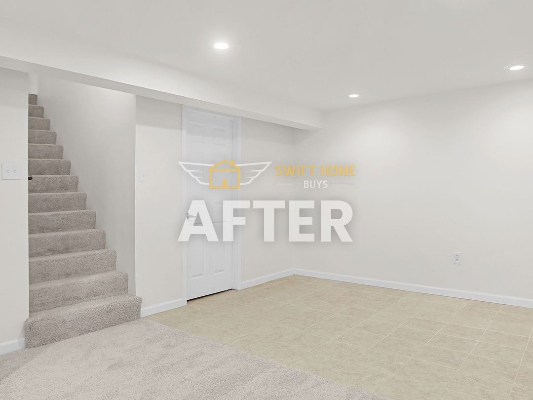 The same Manchester lower level after: fresh white paint, new stair carpet and clean tile