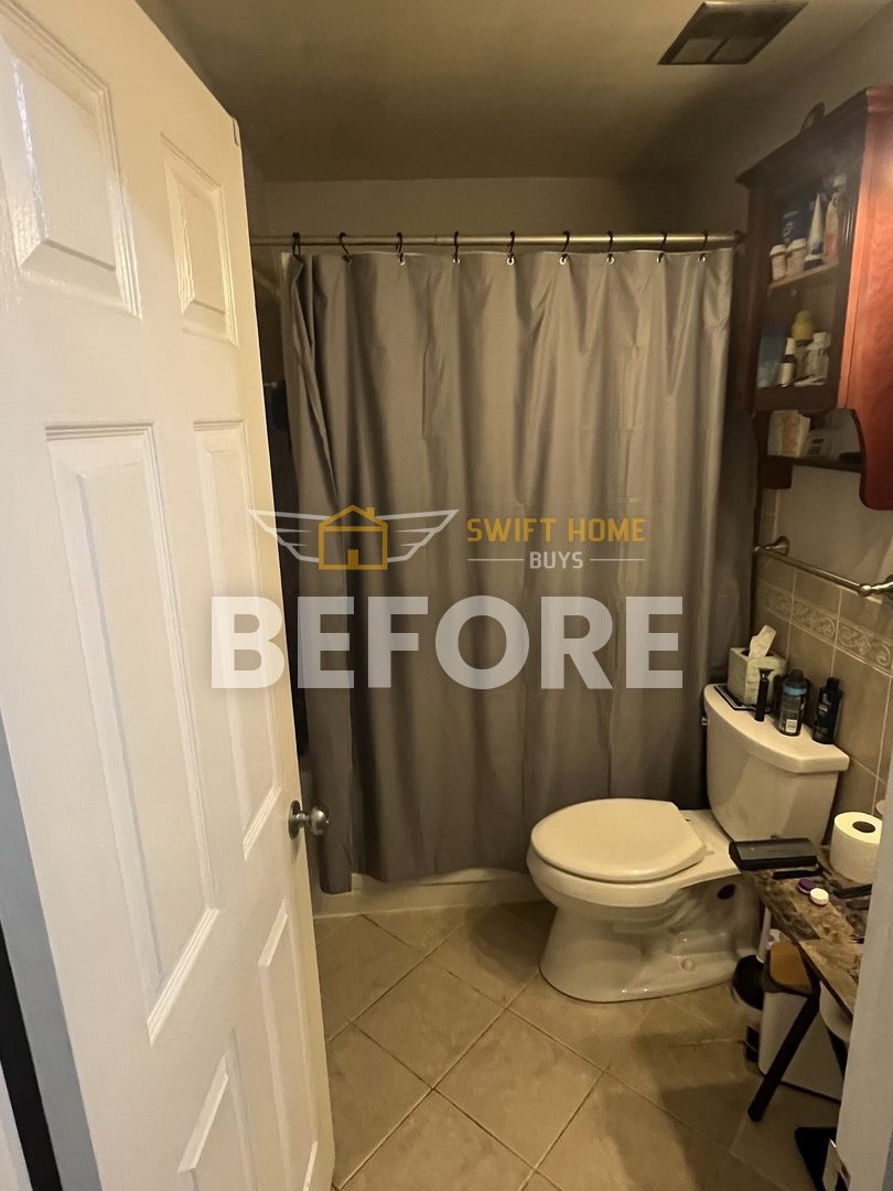 Manchester bathroom before: dated vanity area and shower curtain