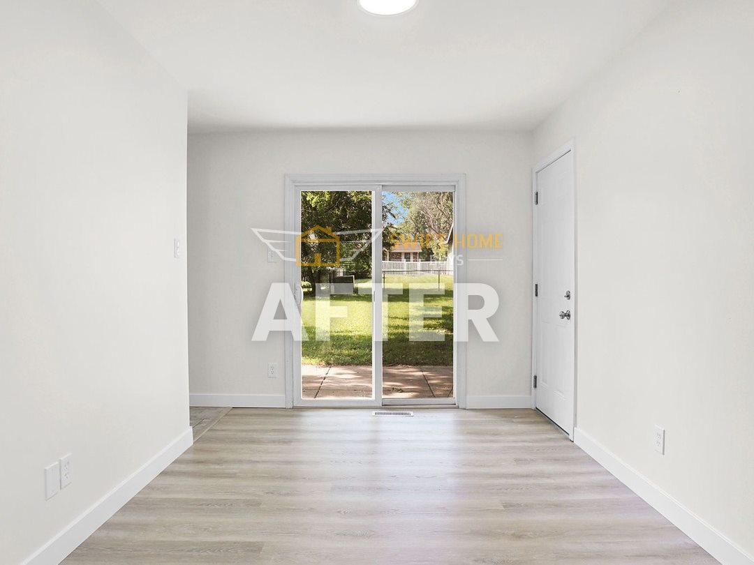 The same Manchester dining area after: light walls, new plank flooring and a new ceiling light