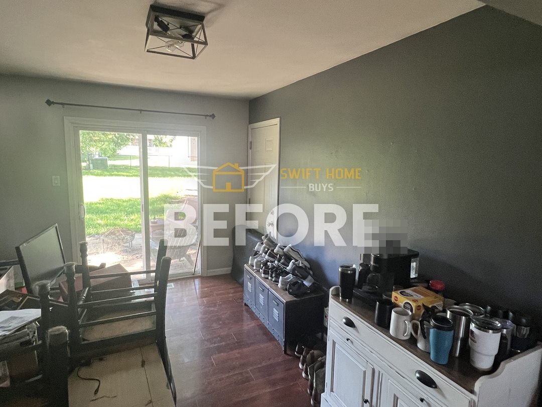 Manchester dining area before: dark accent wall, dated light fixture and cherry laminate floor