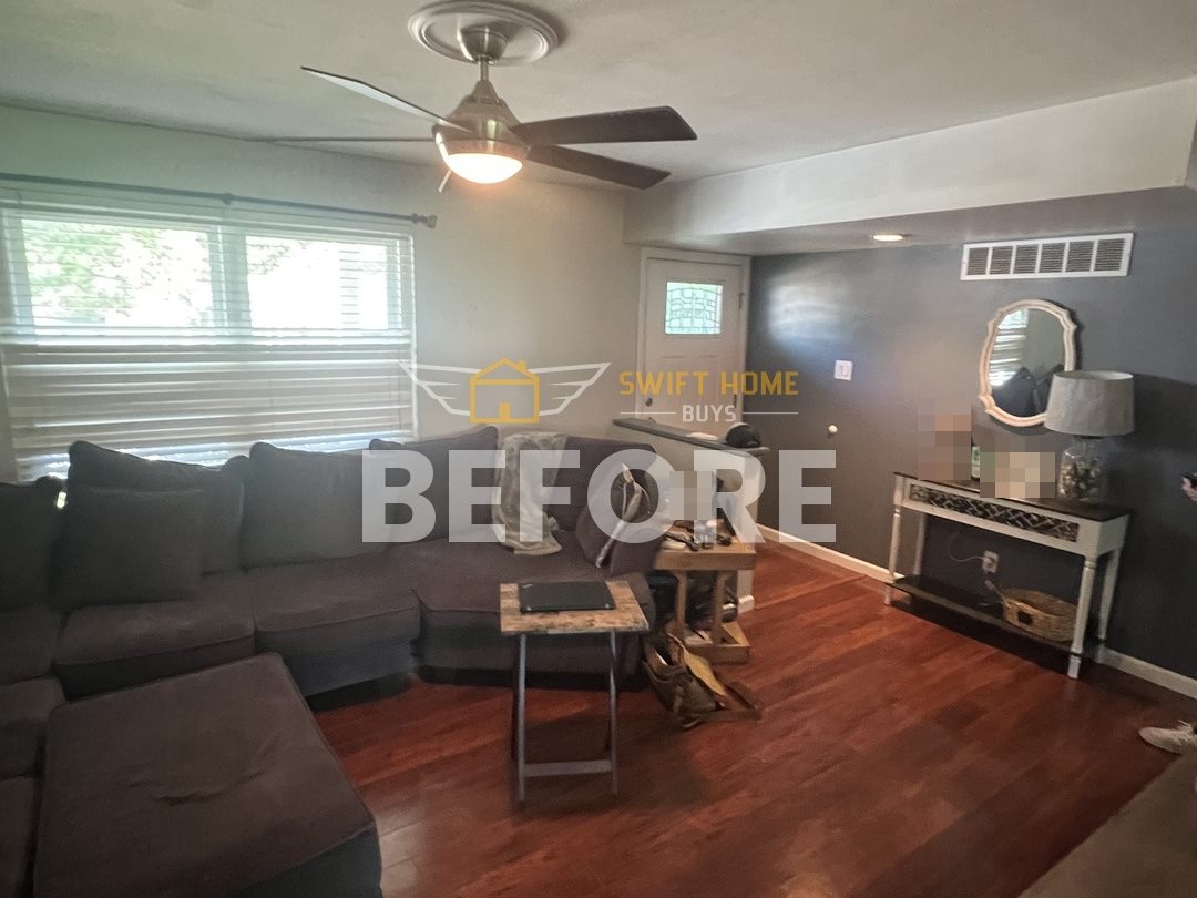 Manchester living room before: dark accent wall, cherry wood floor and a ceiling fan