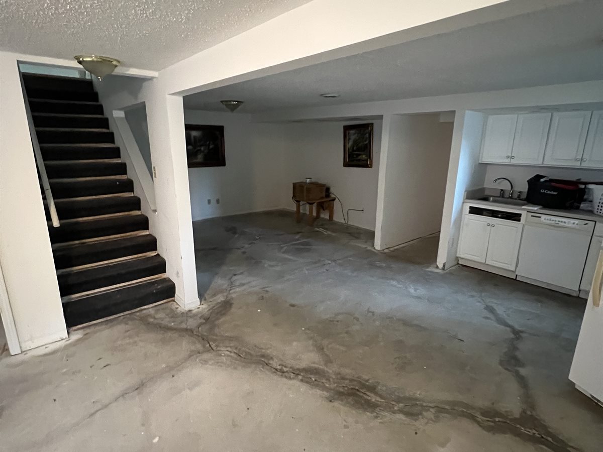 Chesterfield basement before: bare, cracked concrete floor with no flooring installed