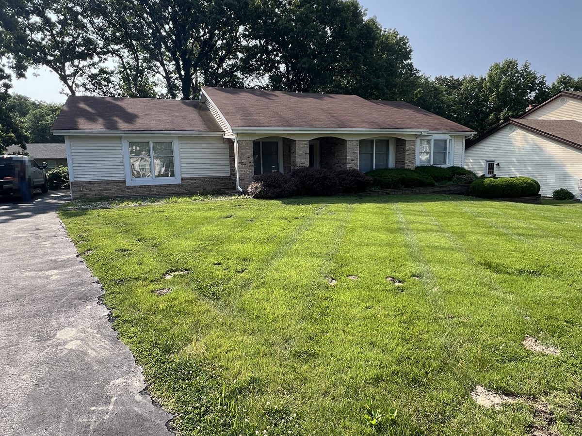 Chesterfield ranch before, with a brown roof and a patchy front lawn