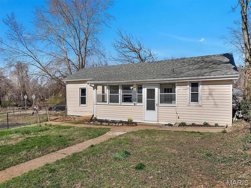 Small one-story house in Lemay, MO, after Swift Home Buys renovated it, with a new roof and an enclosed front porch