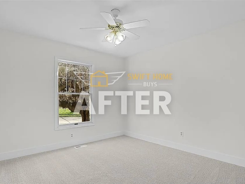 The same St. Charles bedroom after renovation: fresh paint and new carpet