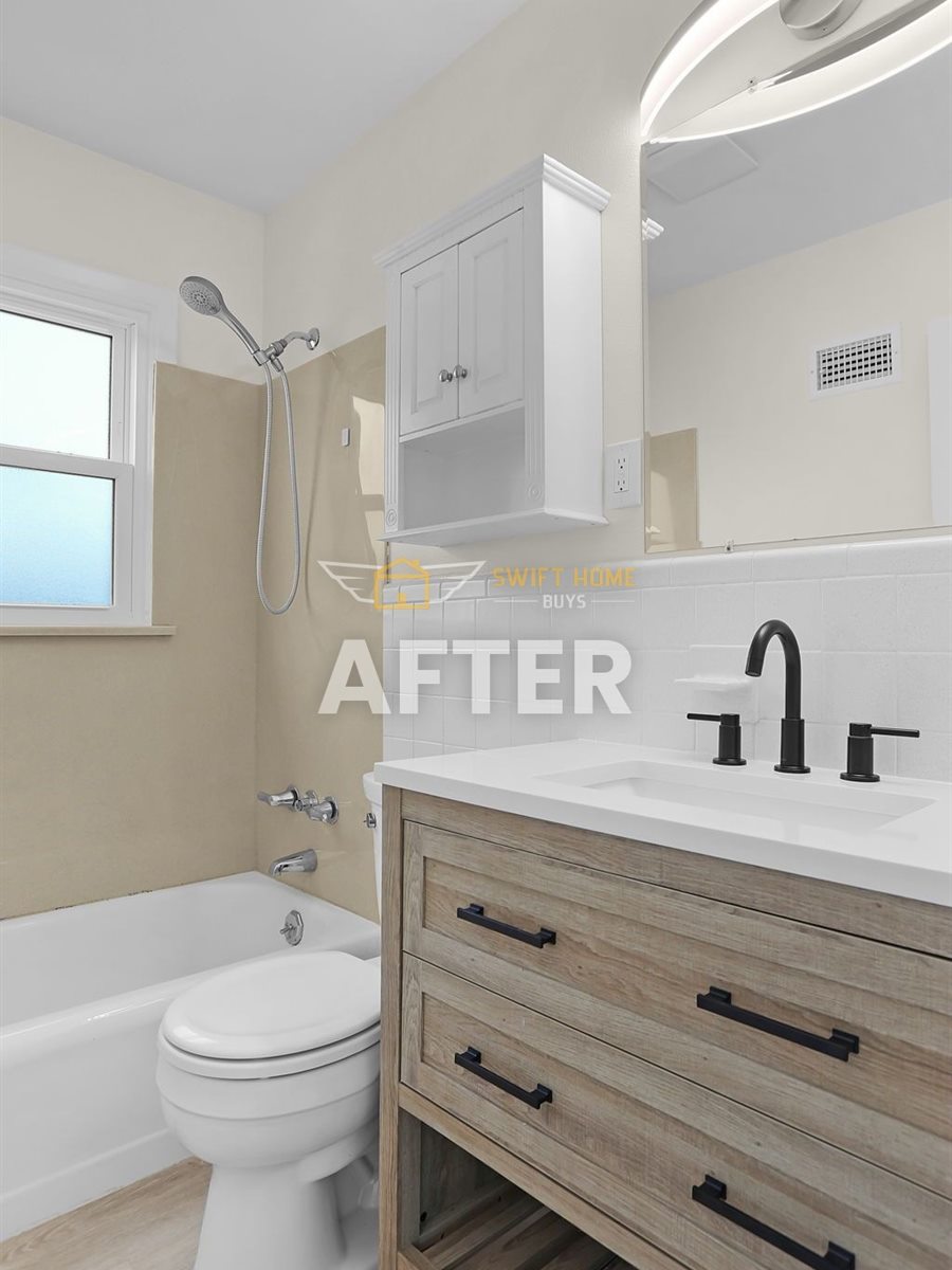 St. Louis County bathroom after renovation: new vanity, black fixtures and fresh paint