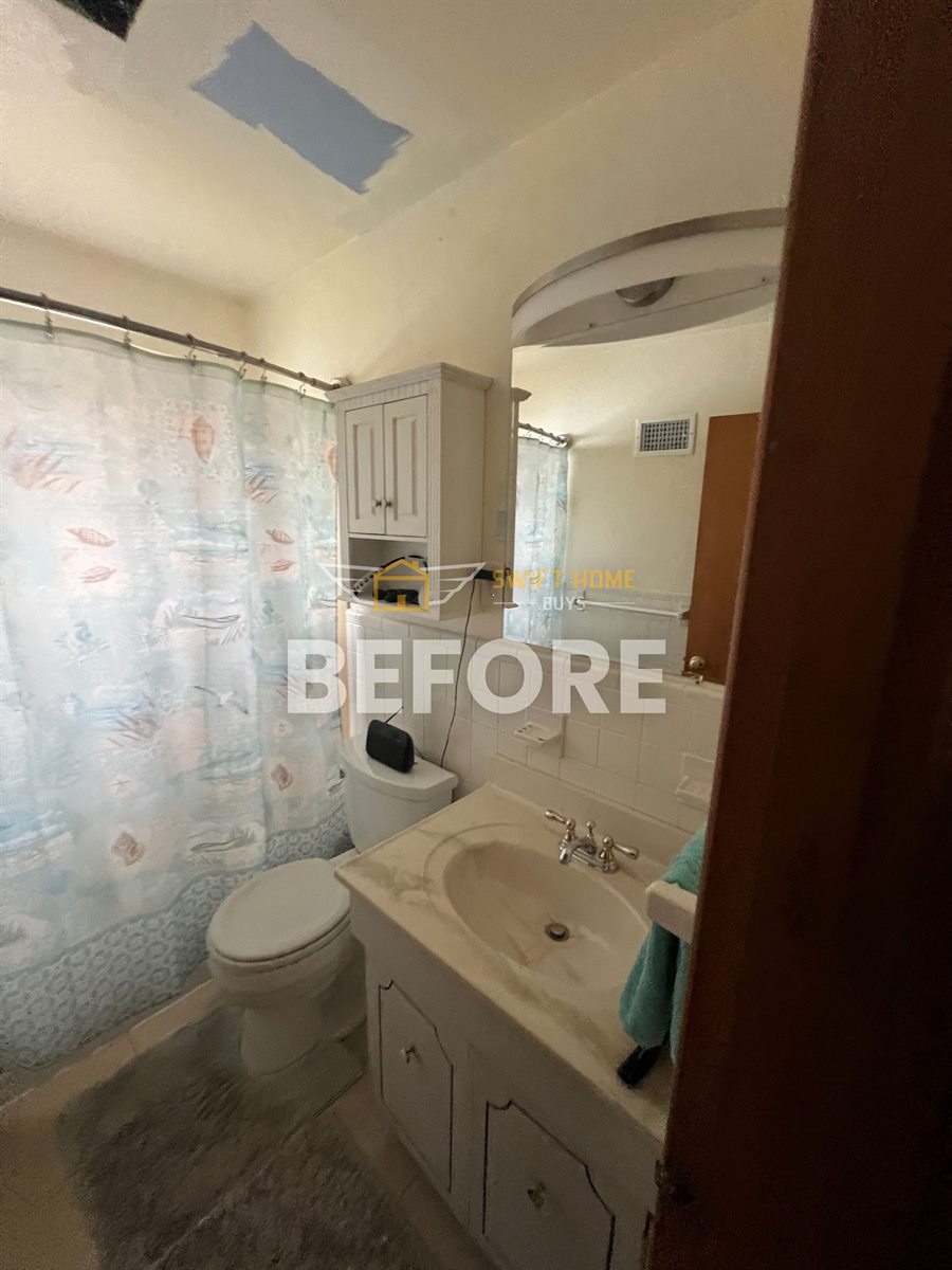 St. Louis County bathroom before: worn vanity and patched ceiling