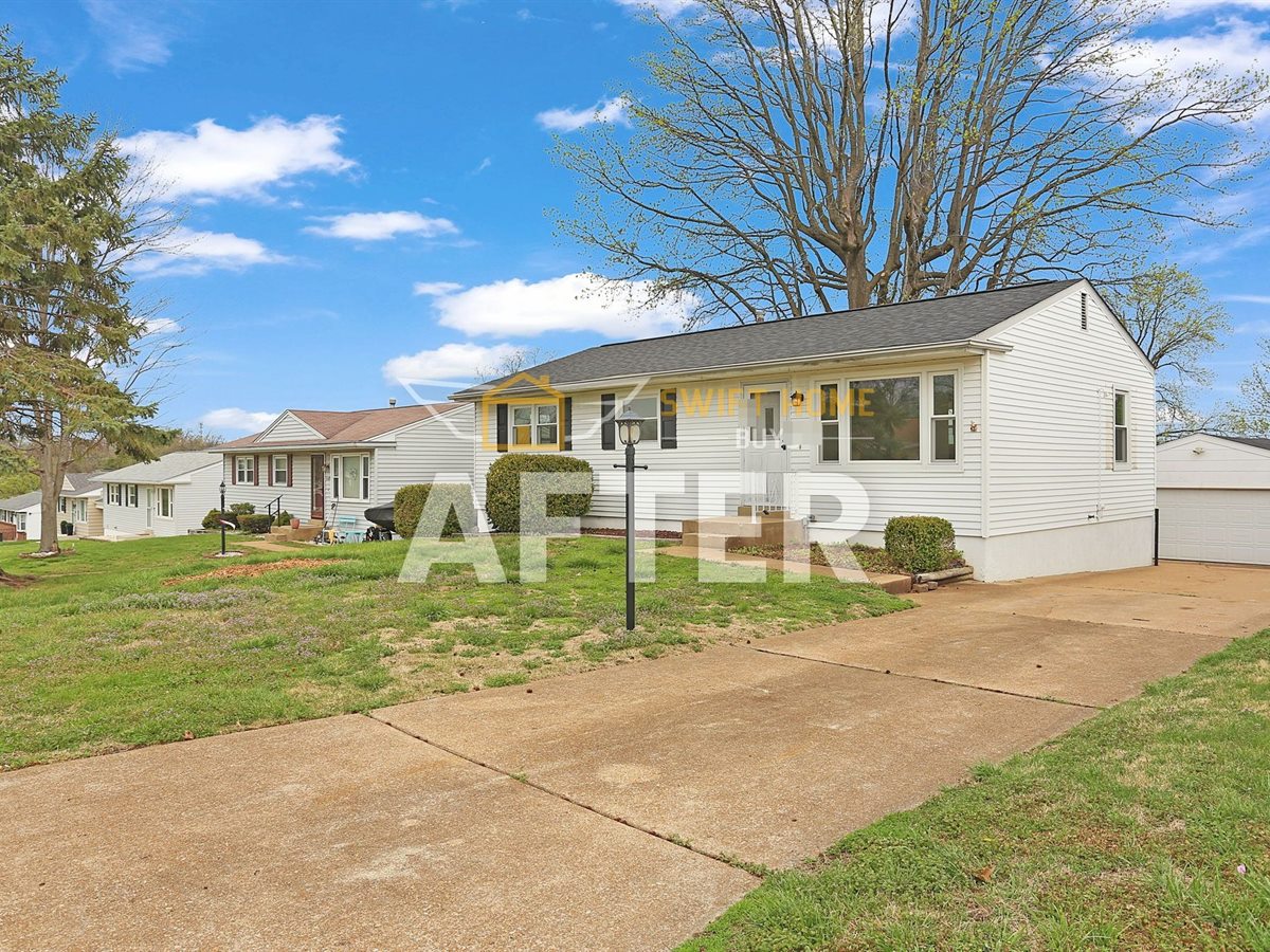 The same St. Louis County ranch house after renovation, with black shutters