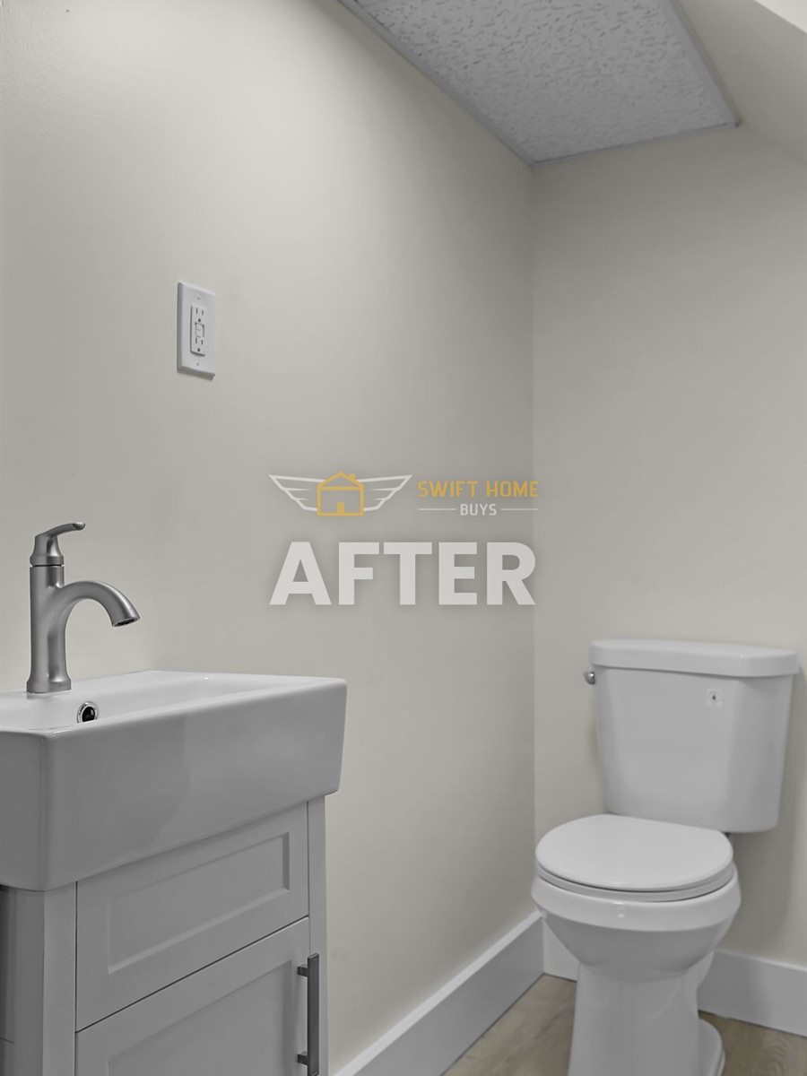 St. Louis County half bath after renovation: new vanity, toilet, flooring and paint