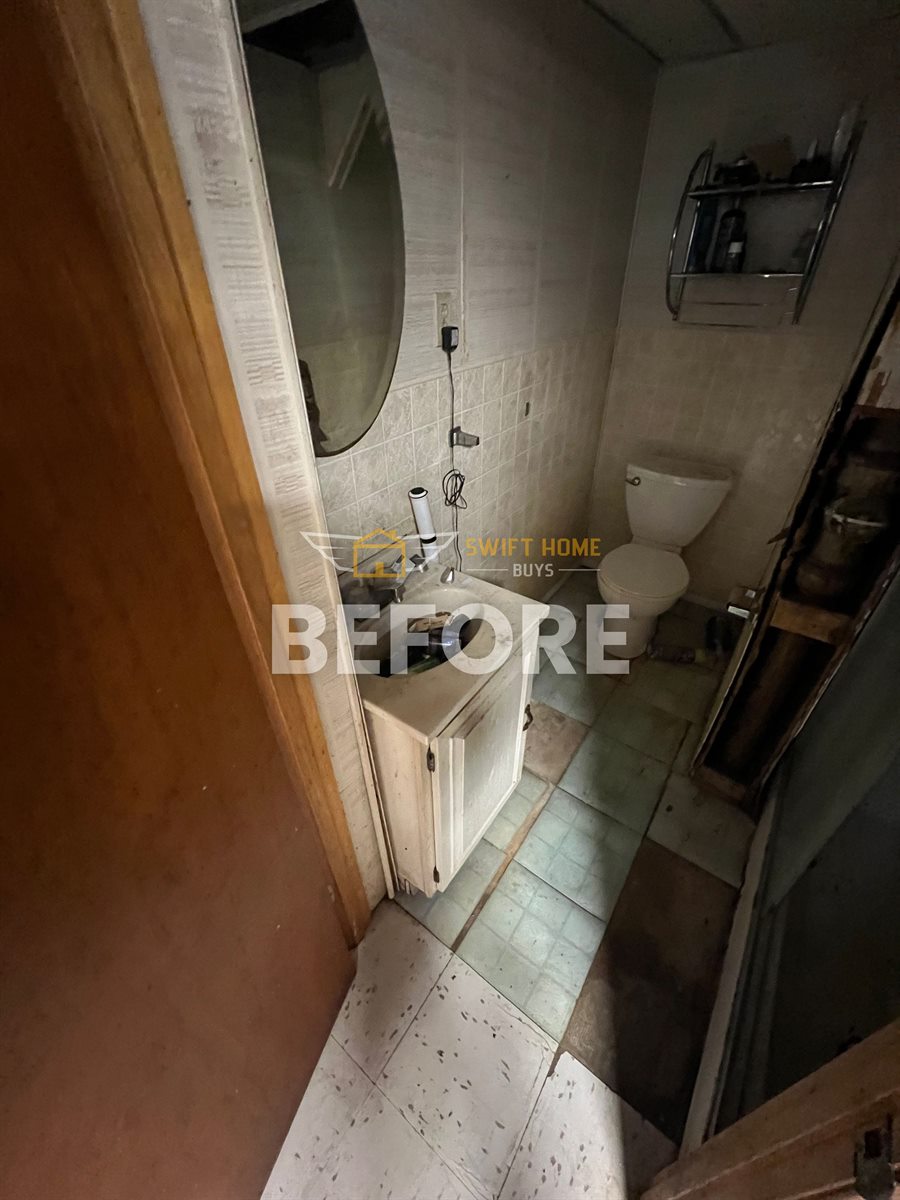 St. Louis County half bath before: dark, dated and partly torn out