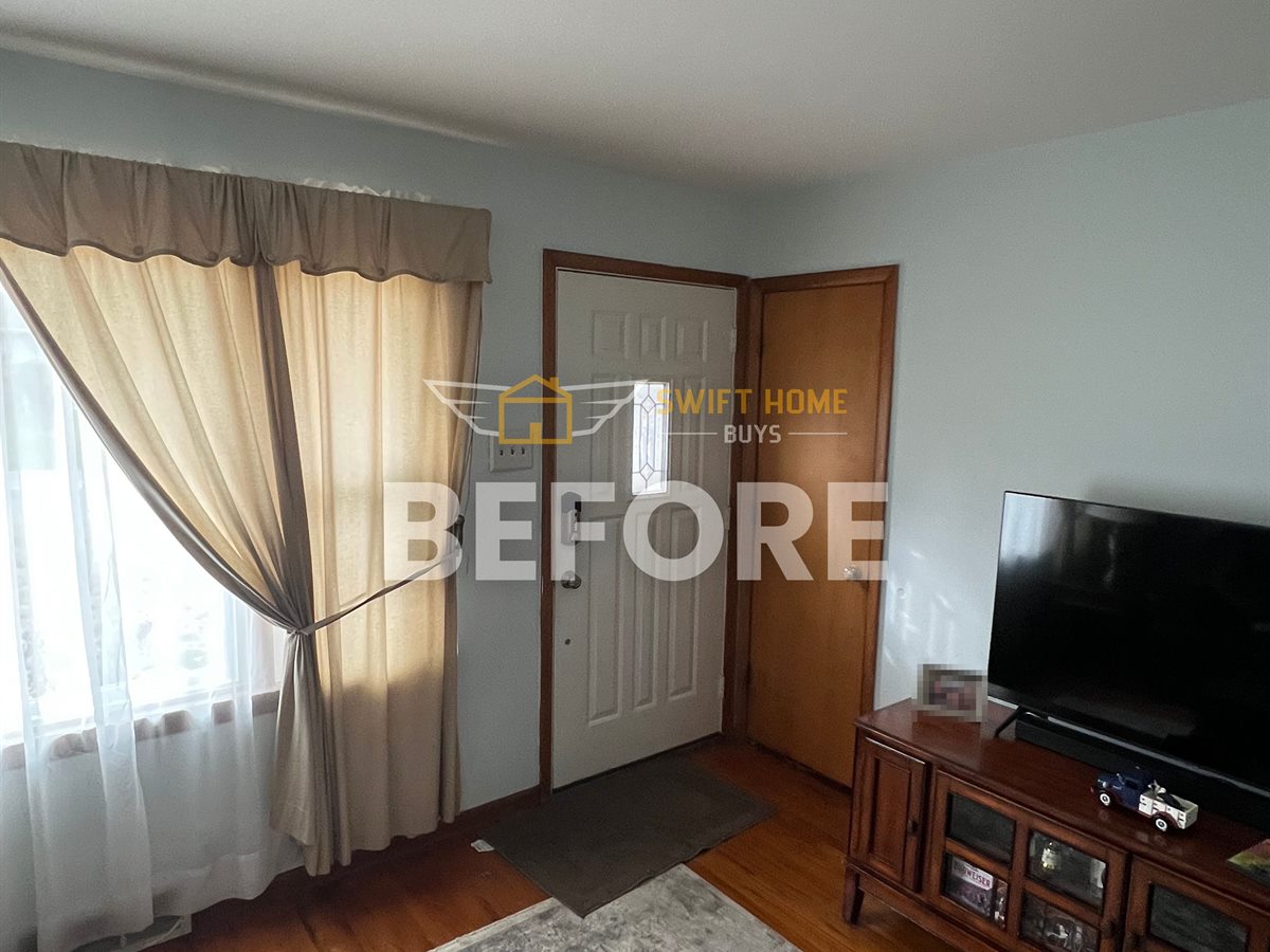 St. Louis County living room before: dated paint, older wood floor and heavy curtains