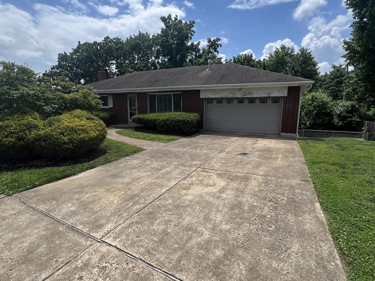Sunset Hills brick ranch before, with a weathered garage header and an old roof