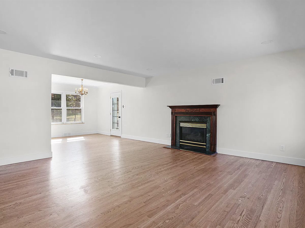 The same Sunset Hills living room after: refinished hardwood, fresh paint and new baseboards