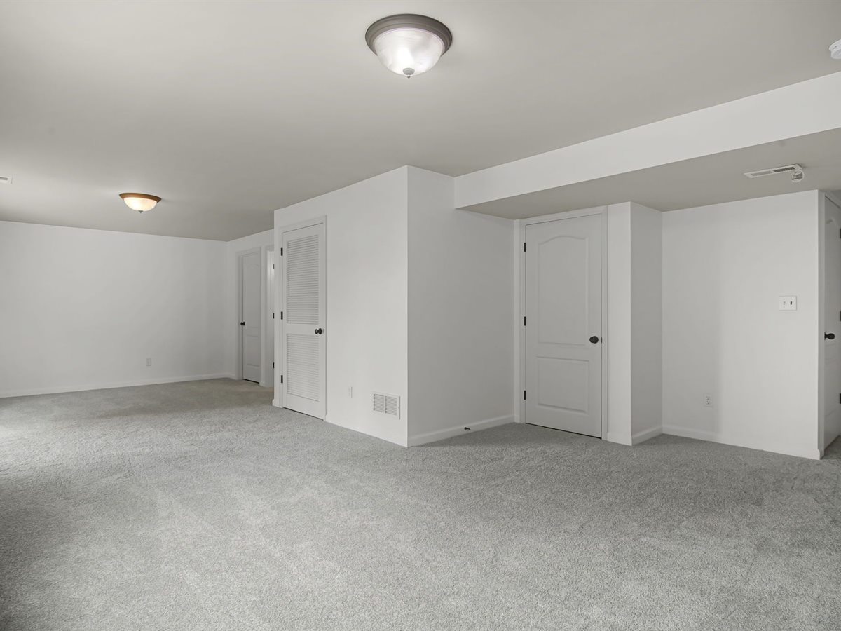 The same Wentzville lower level after: new gray carpet and fresh white paint